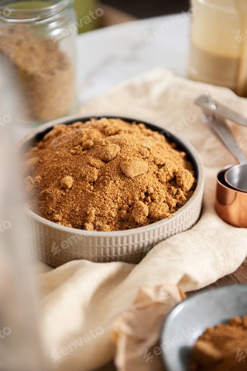 Preview: Vertical closeup of mushroom powder on a white bowl on the table blurred background