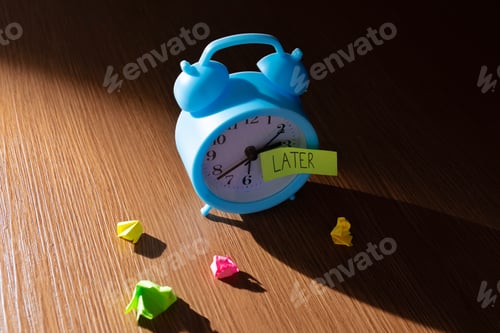 Preview: A vintage alarm clock against a dark background with a note "LATER".
