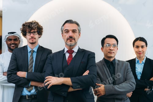 Preview: A group of different business people are sitting around a big meeting table in a modern office.