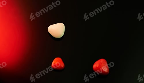 Preview: Valentine's Day candies on red black background. Red candy hearts with space for text