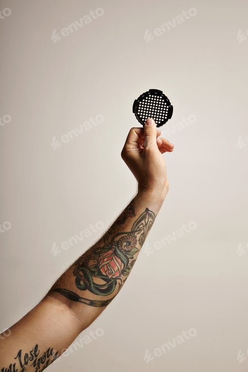 Preview: Tattoed arm and hand with aeropress filter cap