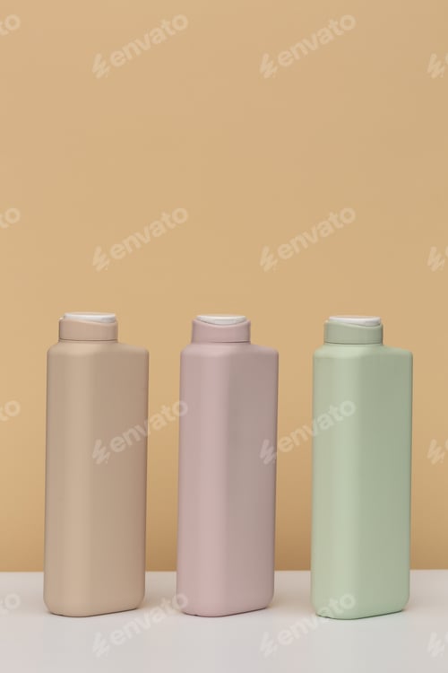 Preview: Three Bottles For Cosmetics Of Different Colours On A Beige Background