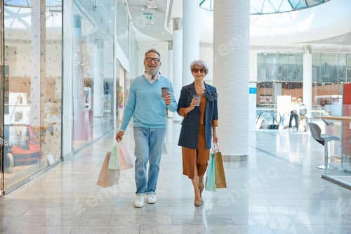 Preview: Fashionable elderly couple enjoying shopping tour on weekends
