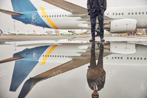 Preview: Portrait of happy confident caucasian airplane crew near plane