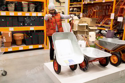 Preview: in a garden supply store, a young man chooses a new garden cart