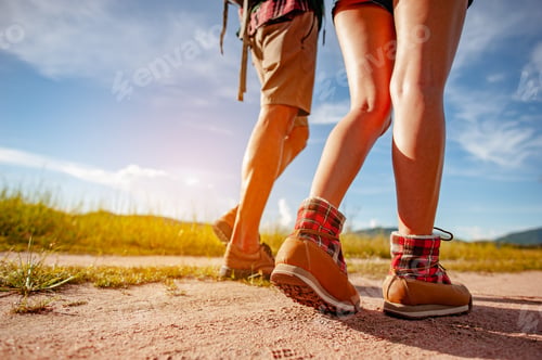Preview: Young couple asian in a wide field is walking on foot to explore the forest as a holiday activity