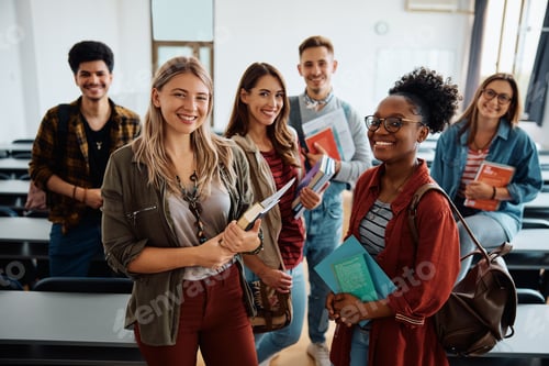 Preview: Multi-ethnic group of university students in lecture hall looking at camera.