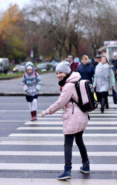 Preview: Schoolgirl crossing the road. Street view. People in the city. Autumn.