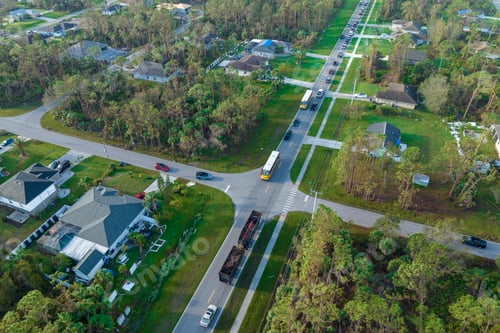 Preview: Top view of classical american yellow school bus picking up kids at rural town street stop
