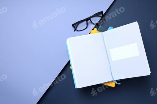 Preview: An open book with glasses on a blue background