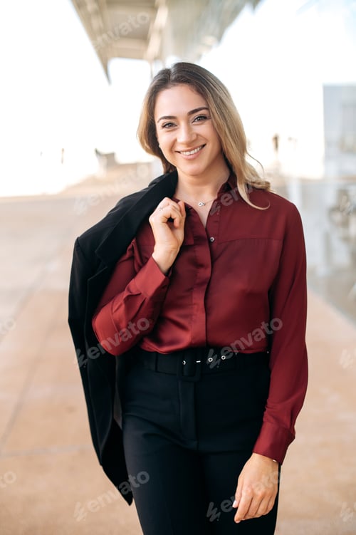 Preview: Confident Woman in Burgundy Shirt and Black Pants