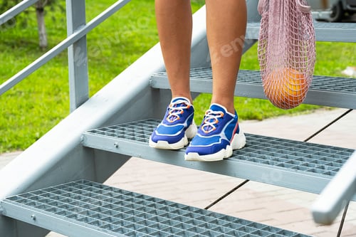 Preview: Woman in Blue Sneakers with Mesh Reusable Eco Bag, Close Up.