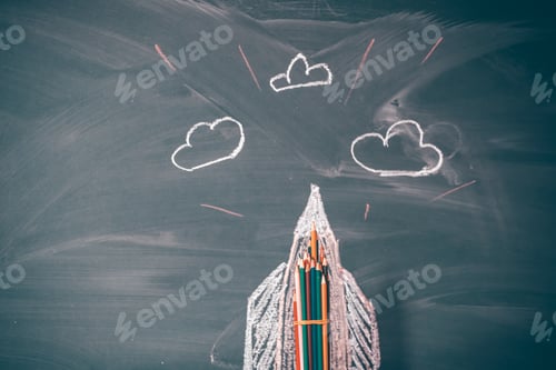 Preview: Back to school background with rocket sketch and pencils over chalkboard