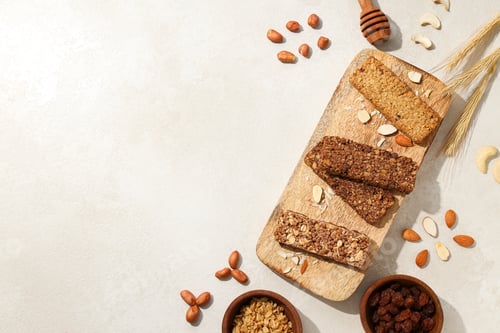 Preview: Granola bars on a wooden board with ears of corn and nuts