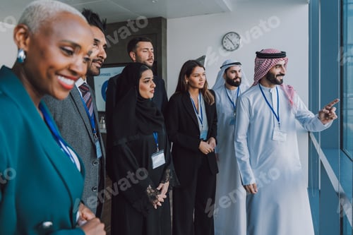 Preview: Multiethnic business team meeting in modern dubai office