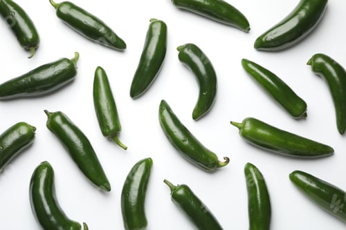 Preview: Green jalapeno peppers on white background, flat lay