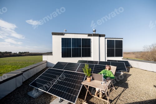 Preview: Woman works on a rooftop with a solar power plant