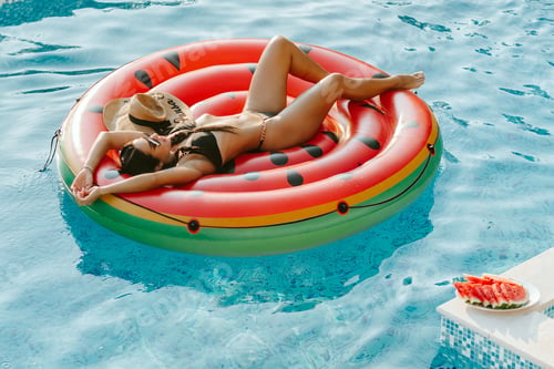Preview: sexy woman relax in swimming pool outdoors at hot summer day