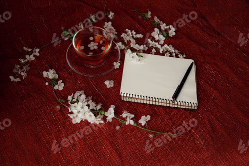Preview: Time for tea, empty notebook, pen and cherry flowers on table