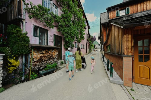 Preview: Mother with baby carriage and children walking in Hallstatt, Austria.
