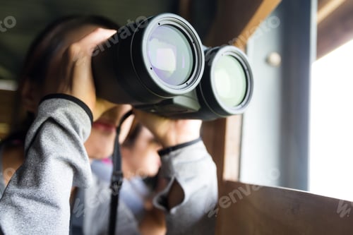 Preview: Asian Woman use of the binoculars for birdwatching