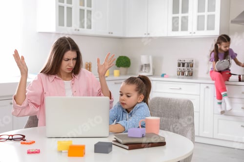 Preview: Children disturbing stressed woman in kitchen. Working from home during quarantine