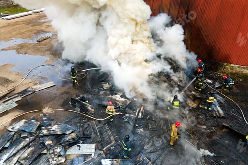 Preview: Aerial view of firefighters extinguishing fire in industrial area