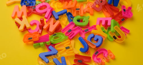 Preview: Multicolored plastic english alphabet letters with magnet on yellow background