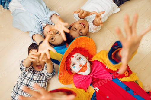 Preview: Clown and children pull hands into the camera