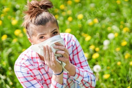 Preview: Young woman having allergic symptoms with tissue