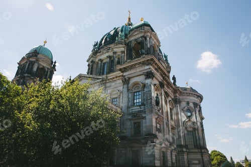 Preview: BERLIN, GERMANY - JUNE 20, 2017: low angle view of historical Berliner Dom of Berlin and blue sky,