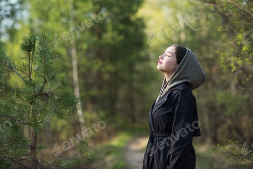 Preview: girl woman walking in nature park forest and breathing fresh air.