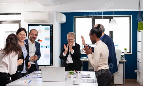 Preview: Motivated happy diverse business team people clapping celebrating