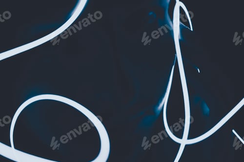 Preview: Neon light against a black background surrounded a human face in the dark