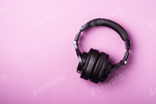 Preview: Classic black wireless headphones on pink minimal background