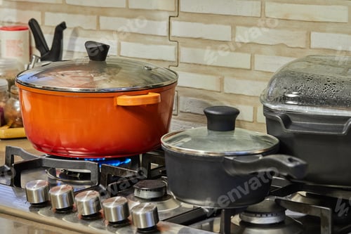 Preview: Preparing food in frying pan and casseroles on the gas stove in the kitchen. Home cooking concept