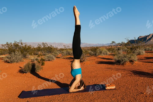Preview: Woman doing headstand in desert
