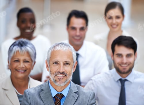 Preview: Portrait of a smiling businessman surrounded by a group of his colleagues