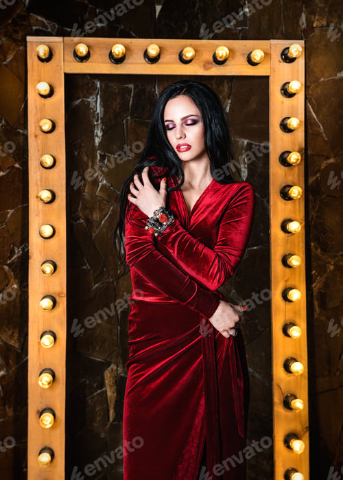 Preview: spoil a white girl in a red dress near a mirror