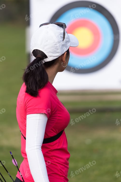 Preview: Female athlete practicing archery in stadium