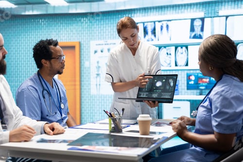 Preview: Team of specialists reviewing ecg results in a meeting at a private clinic