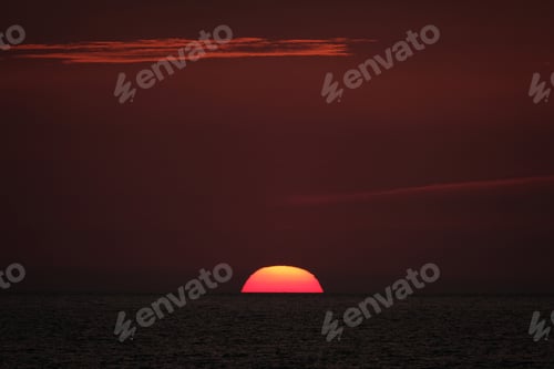 Preview: Beautiful shot of the sun going down in a red sky