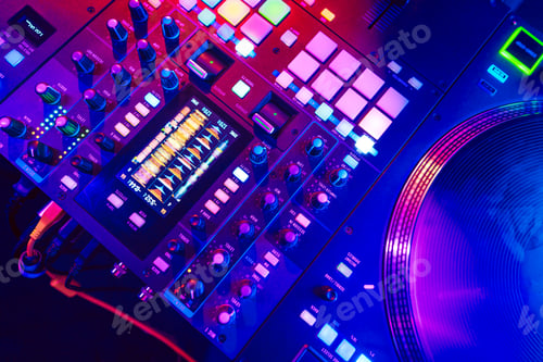 Preview: Close up of DJ mixing console in party light