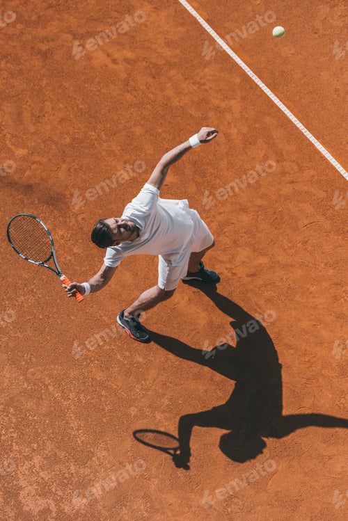 Preview: high angle view of man making hit with tennis racket