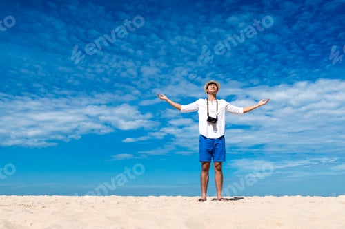 Preview: Young man travel outdoor on tropical beach with blue sky and white cloud using DSLR camera