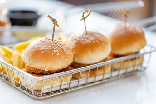 Preview: Mini burgers with french fries served at the bar, finger food, closeup
