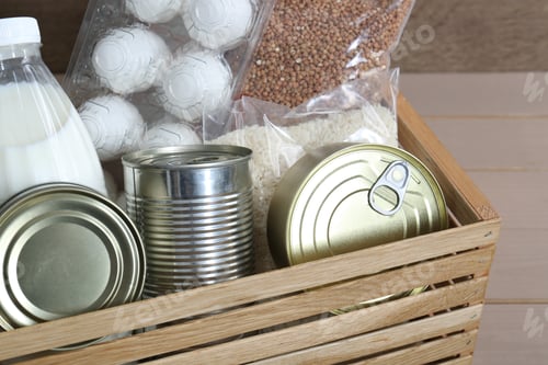 Preview: Donation box with food products on wooden table, closeup