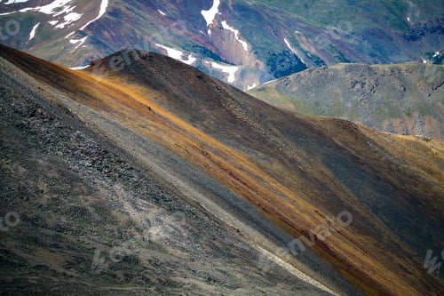 Preview: Rugged Mountain Slopes with Snow Patches