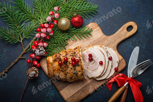 Preview: Christmas baked ham sliced with red berries and festive decorations