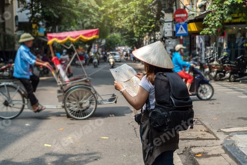 Preview: Asian Traveler holding and looking the map for travel at the hanoi city, vietnam
